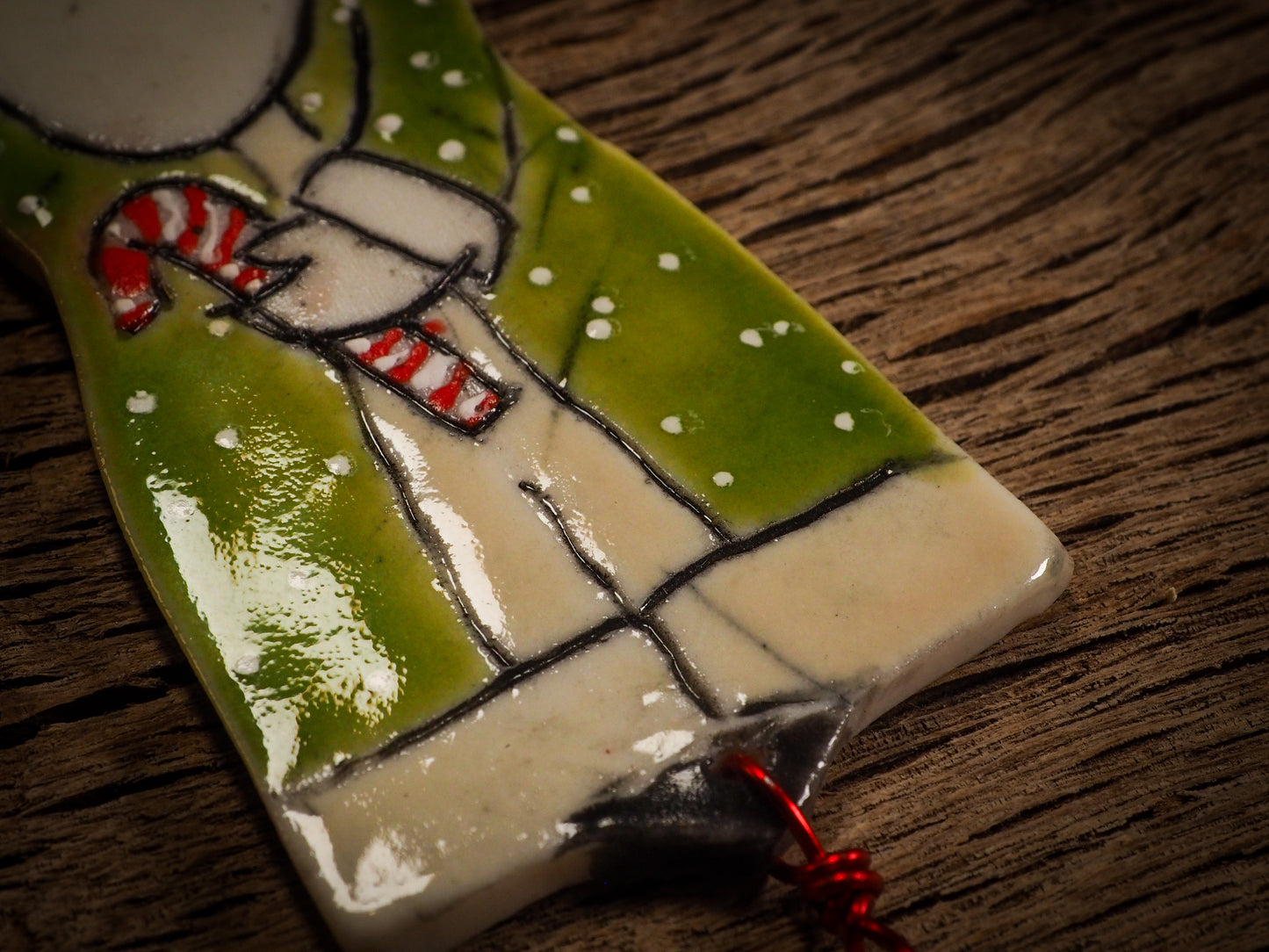 An original Christmas Holiday tree round glazed ceramic ornament handmade by Idania Salcido, the artist behind Danita Art. Glazed carved sgraffito stoneware, hand painted and decorated, it is illustrated by hand with snowmen, Christmas trees, Santa Claus, angels and snow balls and winter themes.
