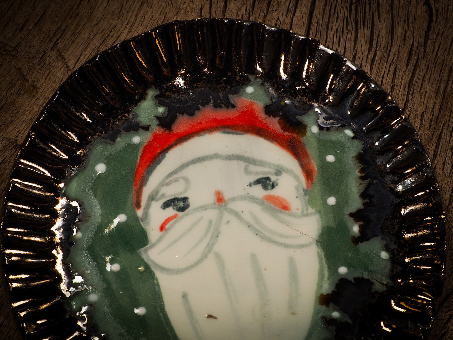 An original Christmas Holiday cake dinner dessert plate round glazed ceramic dinnerware handmade by Idania Salcido, the artist behind Danita Art. Glazed carved sgraffito stoneware, hand painted and decorated, it is illustrated by hand with snowmen, Christmas trees, Santa Claus, angels and snowballs and winter themes.