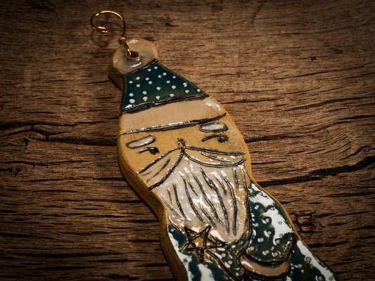 An original Christmas Holiday tree round glazed ceramic ornament handmade by Idania Salcido, the artist behind Danita Art. Glazed carved sgraffito stoneware, hand painted and decorated, it is illustrated by hand with snowmen, Christmas trees, Santa Claus, angels and snow balls and winter themes.
