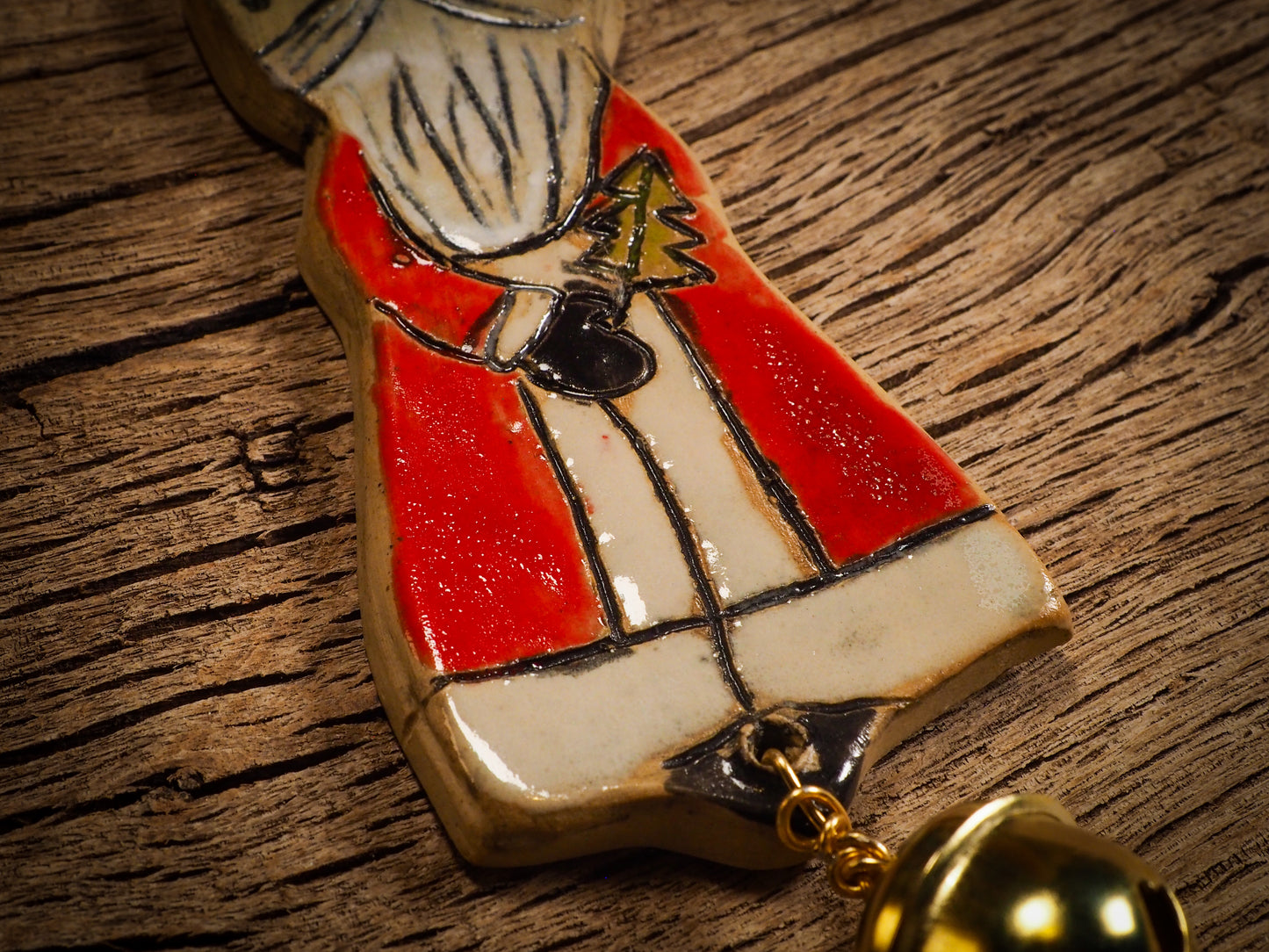 An original Christmas Holiday tree round glazed ceramic ornament handmade by Idania Salcido, the artist behind Danita Art. Glazed carved sgraffito stoneware, hand painted and decorated, it is illustrated by hand with snowmen, Christmas trees, Santa Claus, angels and snow balls and winter themes.