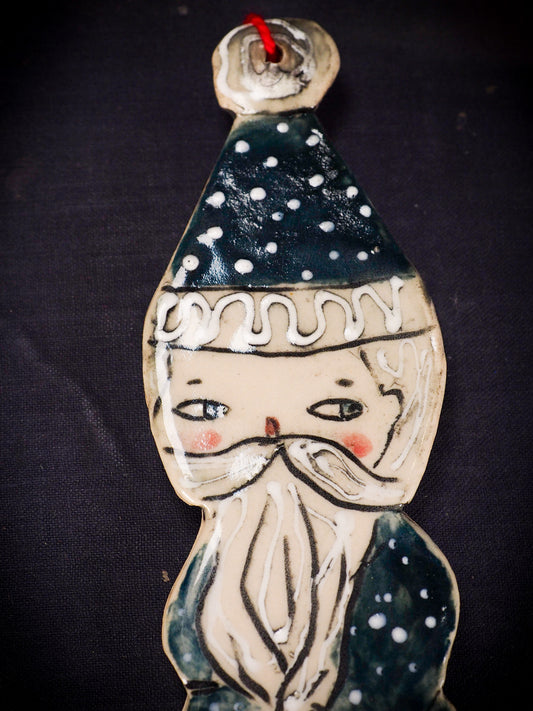 An original Christmas Holiday tree round glazed ceramic ornament handmade by Idania Salcido, the artist behind Danita Art. Glazed carved sgraffito stoneware, hand painted and decorated, it is illustrated by hand with snowmen, Christmas trees, Santa Claus, angels and snow balls and winter themes.