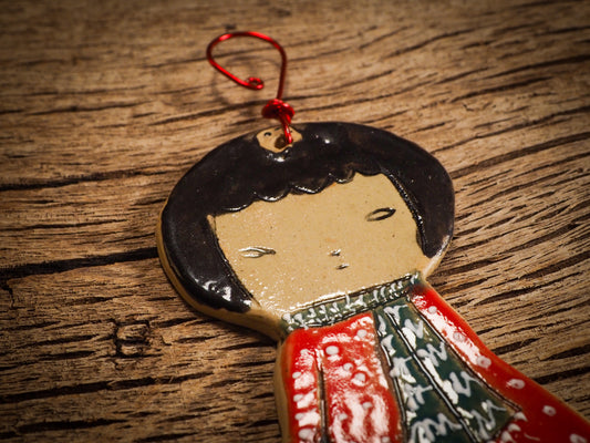 An original Christmas Holiday tree round glazed ceramic ornament handmade by Idania Salcido, the artist behind Danita Art. Glazed carved sgraffito stoneware, hand painted and decorated, it is illustrated by hand with snowmen, Christmas trees, Santa Claus, angels and snow balls and winter themes.