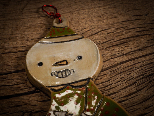 An original Christmas Holiday tree round glazed ceramic ornament handmade by Idania Salcido, the artist behind Danita Art. Glazed carved sgraffito stoneware, hand painted and decorated, it is illustrated by hand with snowmen, Christmas trees, Santa Claus, angels and snow balls and winter themes.