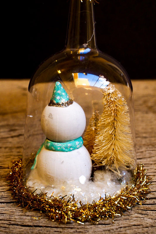An original handmade christmas tree ornament by Idania Salcido. A clear domed diorama with a holiday scene with Santa Claus elves, Christmas Trees, Elves, Gifts and magical glitter deer. Perfect to decorate your Christmas Tree, your mantelpiece or to be used as accents on a dinner table.