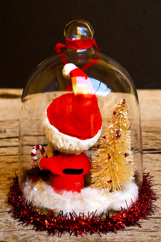 An original handmade christmas tree ornament by Idania Salcido. A clear domed diorama with a holiday scene with Santa Claus elves, Christmas Trees, Elves, Gifts and magical glitter deer. Perfect to decorate your Christmas Tree, your mantelpiece or to be used as accents on a dinner table.