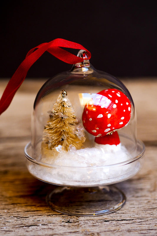 An original handmade christmas tree ornament by Idania Salcido. A clear domed diorama with a holiday scene with Santa Claus elves, Christmas Trees, Elves, Gifts and magical glitter deer. Perfect to decorate your Christmas Tree, your mantelpiece or to be used as accents on a dinner table.