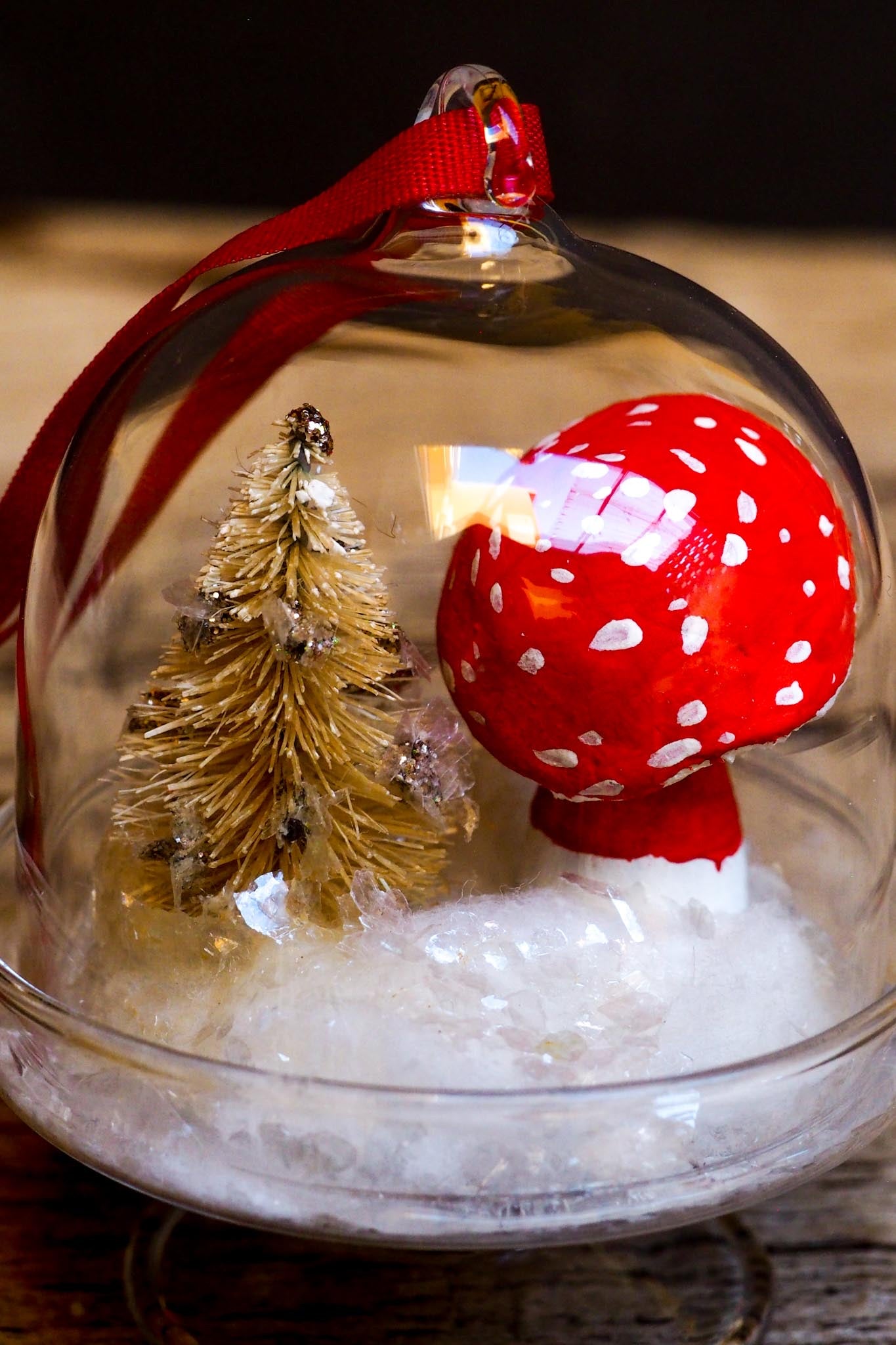 An original handmade christmas tree ornament by Idania Salcido. A clear domed diorama with a holiday scene with Santa Claus elves, Christmas Trees, Elves, Gifts and magical glitter deer. Perfect to decorate your Christmas Tree, your mantelpiece or to be used as accents on a dinner table.