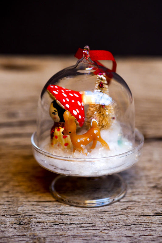 An original handmade christmas tree ornament by Idania Salcido. A clear domed diorama with a holiday scene with Santa Claus elves, Christmas Trees, Elves, Gifts and magical glitter deer. Perfect to decorate your Christmas Tree, your mantelpiece or to be used as accents on a dinner table.