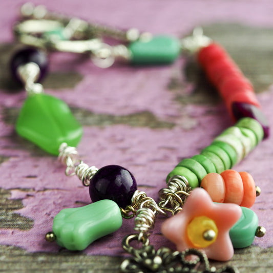 Two sisters enjoy the joy of baking in this original bracelet by Da its Art. Glass beads and jade make this colorful and beautiful piece of wearable art.