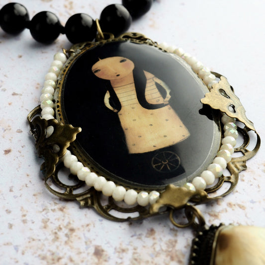 The unicycle, a pop surrrealist and whimsical by Danita, made into a hand made necklace.