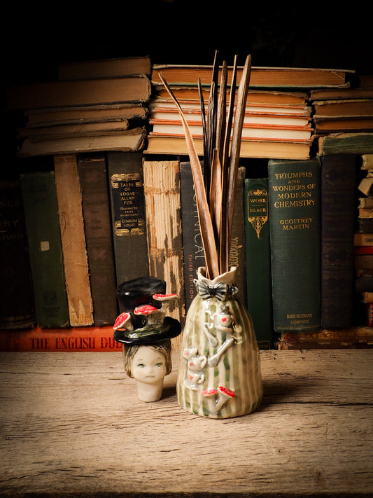 Flower pot container ceramic figure inspired by Alice in Wonderland made by Idania Salcido, the mixed media artist and ceramist behind Danita Art. Earth clay is hand sculpted and glazed and kiln fired to create a ceramic home decor heirloom figurine. Each unique art piece is a one of a kind fine pottery artwork.