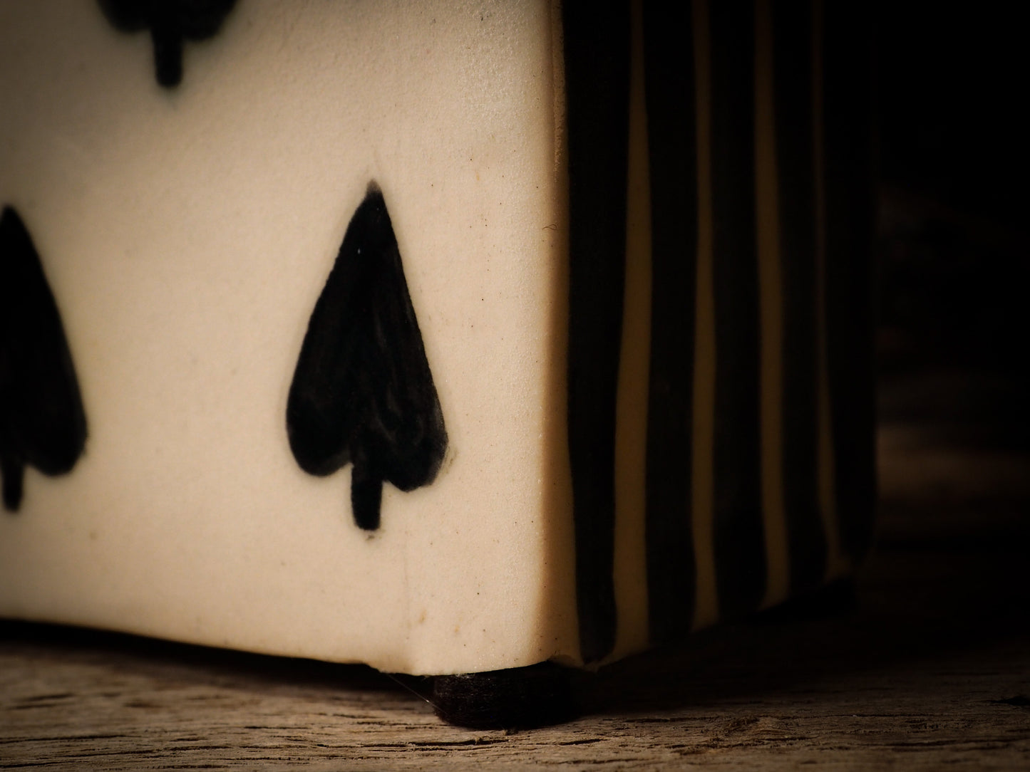 five of spades card glazed ceramic figure inspired by Alice in Wonderland made by Idania Salcido, the mixed media artist and ceramist behind Danita Art. Earth clay is hand sculpted and glazed and kiln fired to create a ceramic home decor heirloom figurine. Each unique art piece is a one of a kind fine pottery artwork.