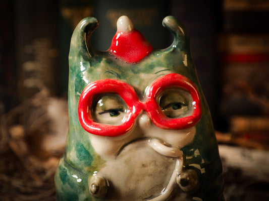 green caterpillar toadstool ceramic figure inspired by Alice in Wonderland made by Idania Salcido, the mixed media artist and ceramist behind Danita Art. Earth clay is hand sculpted and glazed and kiln fired to create a ceramic home decor heirloom figurine. Each unique art piece is a one of a kind fine pottery artwork.