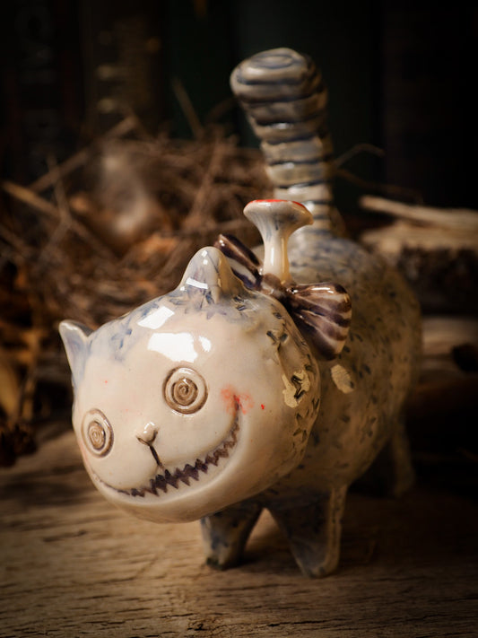 Cheshire Cat vintage pet ceramic figure inspired by Alice in Wonderland made by Idania Salcido, the mixed media artist and ceramist behind Danita Art. Earth clay is hand sculpted and glazed and kiln fired to create a ceramic home decor heirloom figurine. Each unique art piece is a one of a kind fine pottery artwork.