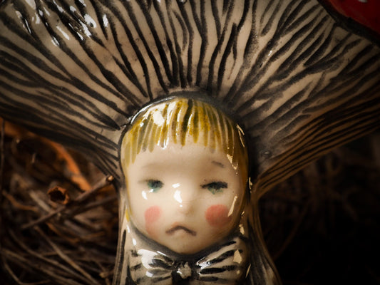 red toadstool mushroom fungi glazed ceramic torso figure inspired by Alice in Wonderland by Idania Salcido, the artist behind Danita Art. Lumps of clay hand sculpted and glazed are kiln fired. Beautiful fungi shaped wall hangings with nail hole in the back to place on wall with a hook or display on shelf or showcase.