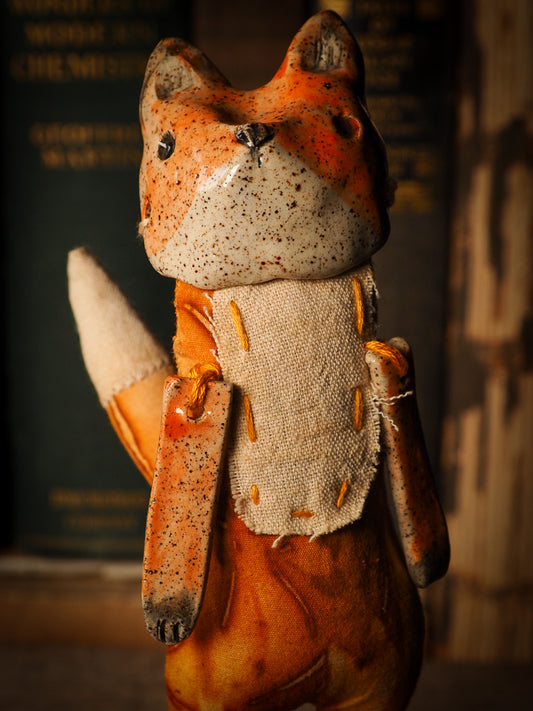 An adorable hand made porcelain and fabric fine art doll by Idania Salcido Danita Art. Perfect to hang as a delicate Christmas tree ornament, this fired ceramic mixed media artwork is unique. Each doll has a beautiful hand sculpted porcelain ceramic face and hand dyed fabric body with vintage accessories as home decor.