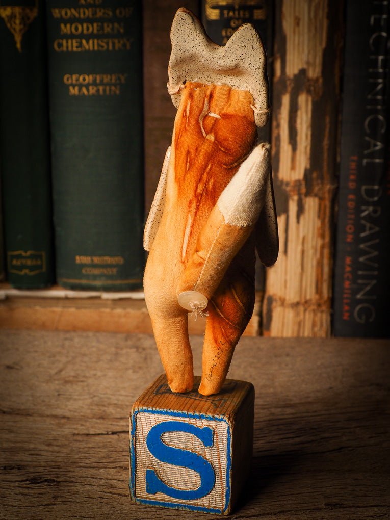 An adorable hand made porcelain and fabric fine art doll by Idania Salcido Danita Art. Perfect to hang as a delicate Christmas tree ornament, this fired ceramic mixed media artwork is unique. Each doll has a beautiful hand sculpted porcelain ceramic face and hand dyed fabric body with vintage accessories as home decor.