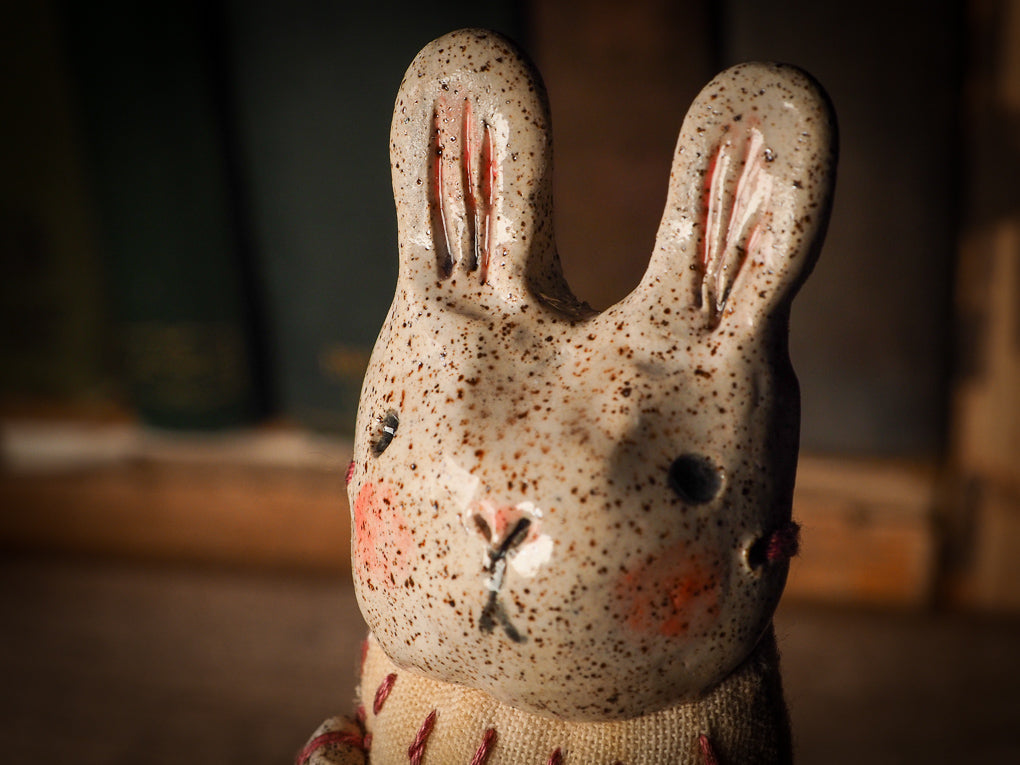 An adorable hand made porcelain and fabric fine art doll by Idania Salcido Danita Art. Perfect to hang as a delicate Christmas tree ornament, this fired ceramic mixed media artwork is unique. Each doll has a beautiful hand sculpted porcelain ceramic face and hand dyed fabric body with vintage accessories as home decor.