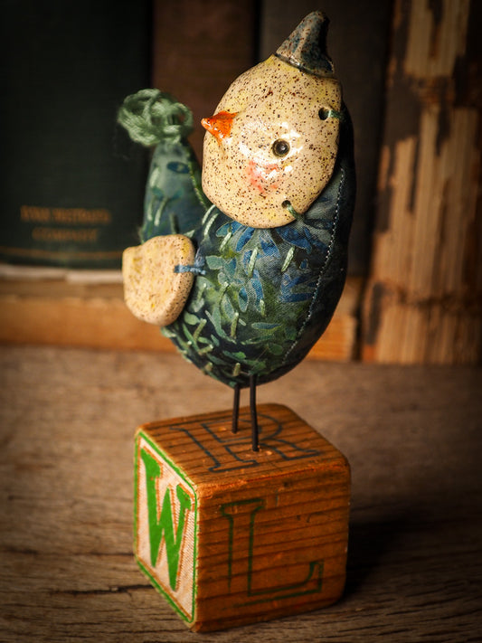 An adorable hand made porcelain and fabric fine art doll by Idania Salcido Danita Art. Perfect to hang as a delicate Christmas tree ornament, this fired ceramic mixed media artwork is unique. Each doll has a beautiful hand sculpted porcelain ceramic face and hand dyed fabric body with vintage accessories as home decor.