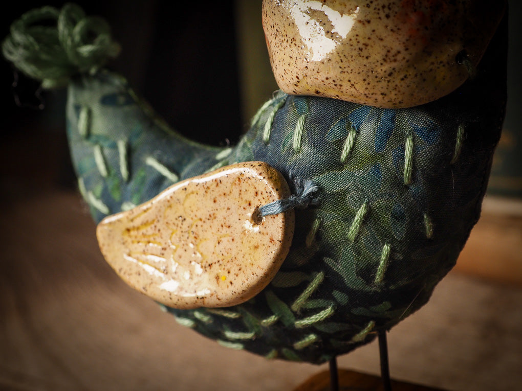 An adorable hand made porcelain and fabric fine art doll by Idania Salcido Danita Art. Perfect to hang as a delicate Christmas tree ornament, this fired ceramic mixed media artwork is unique. Each doll has a beautiful hand sculpted porcelain ceramic face and hand dyed fabric body with vintage accessories as home decor.