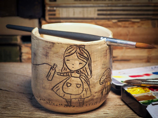 I made this ceramic paint water holder for artists like you and me. It's handmade on my studio by me, Idania Salcido, the artist behind Danita Art. It's glazed and made to hold water for brushes, with a little notch on top to hold your favorite brush and it can be used with acrylics, oils and watercolors.