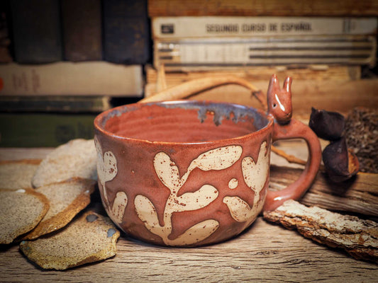 Handmade carved ceramic coffee mug created by Idania Salcido, the artist behind Danita Art, and fired and glazed on my own kiln. The inside is a beautiful combination of brown and blue glazes, combining inside like cream and coffee. A bunny rabbit on the handle and flowers on the sides make it a unique item decoration.