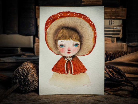 This series of original watercolors portraits by me, Idania Salcido, the artist behind Danita Art, depicts a group of faeries, or maybe girls, playing as mushrooms, with their caps as hats, my signature beautiful and expressive eyes, and capes as their clothes. They are ready to be framed as soon as they arrive!