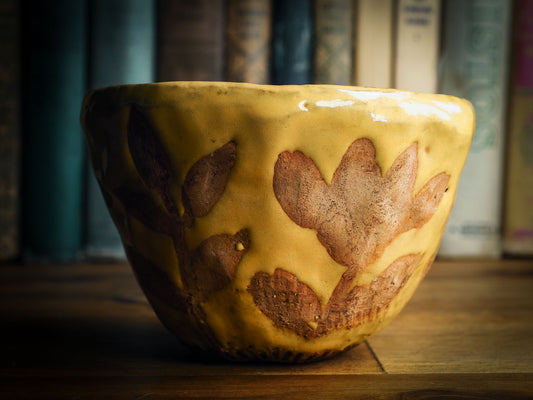 Original fired earthenware ceramic hand pinched bowl with yellow and brown flowers glazed and hand painted motif by Idania Salcido, the artist behind danita Art.