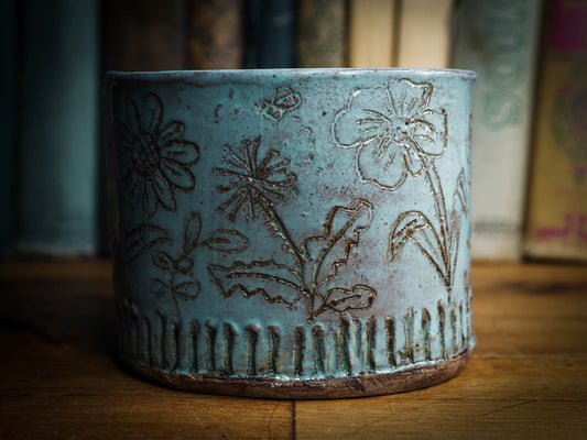 An original Idania Salcido Danita Art pinched ceramic cat pet food bowl. Handmade from locally foraged clay, this glazed ceramics one of a kind artwork is perfect for any kitchen plate and bowls unique collection. Thumbprints and intentionally irregular shape give the bowl a cozy, warmly familiar feel when you pick it. It has a blue bird and flowers carved on the sides of this beautiful vase or bowl.