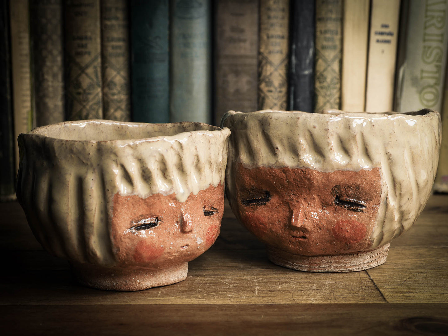 An original Idania Salcido Danita Art pinched ceramic cat pet food bowl. Handmade from locally foraged clay, this glazed ceramics one of a kind artwork is perfect for any kitchen plate and bowls unique collection. Thumbprints and intentionally irregular shape give the bowl a cozy, warmly familiar feel when you pick it. An adorable face like the ones Danita paints and makes dolls with is featured!