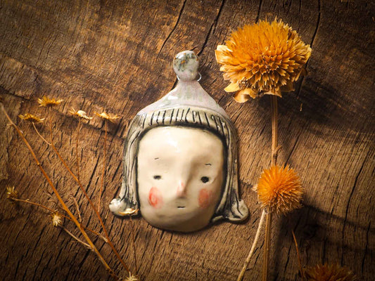 You are looking at an original handmade ceramic hanging face figurine by Idania Salcido, the artist behind Danita Art. Each one is a unique work of art on itself, designed and hand built by me, Idania Salcido. It will add a beautiful handmade touch to any artist's studio, and it's cute details will let your inspiration flow freely.