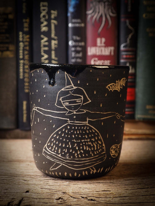 An original Halloween ceramic bowl by Idania Salcido, the artist behind Danita Art. Made with wheel thrown clay, hand carved and glazed by the artist. The carved witches, ghosts, goblins and vampires give it a nice, folk art primitive feel to it. Perfect for Halloween Candy, ice cream and fruit and as pet cat bowl.