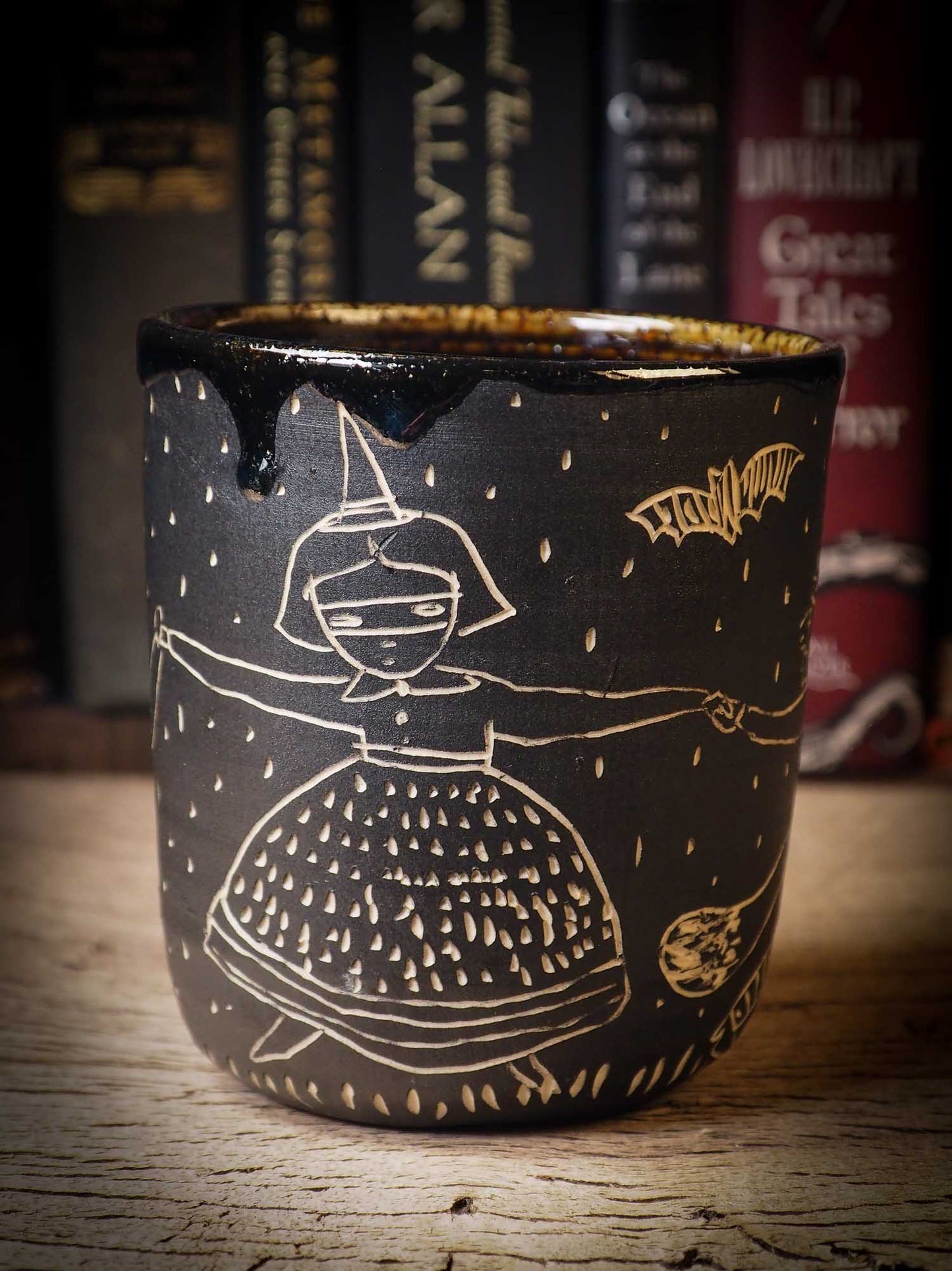 An original Halloween ceramic bowl by Idania Salcido, the artist behind Danita Art. Made with wheel thrown clay, hand carved and glazed by the artist. The carved witches, ghosts, goblins and vampires give it a nice, folk art primitive feel to it. Perfect for Halloween Candy, ice cream and fruit and as pet cat bowl.