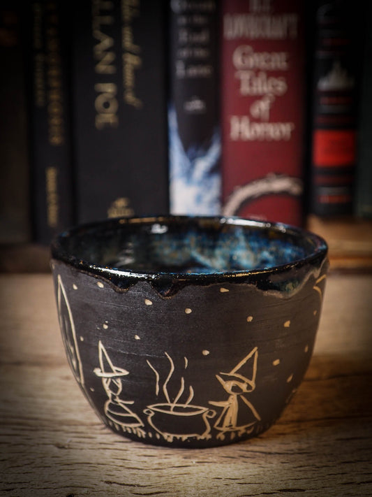 An original Halloween ceramic tumbler bowl by Idania Salcido, the artist behind Danita Art. Made with wheel thrown clay, hand carved and glazed by the artist. The carved witches, ghosts, goblins and vampires give it a nice, folk art primitive feel to it. Perfect for Halloween Candy, ice cream and fruit, a pet cat bowl.