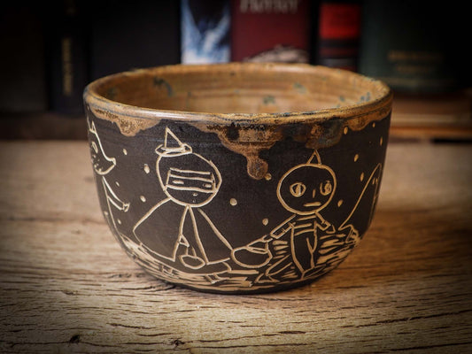 An original Halloween ceramic tumbler bowl by Idania Salcido, the artist behind Danita Art. Made with wheel thrown clay, hand carved and glazed by the artist. The carved witches, ghosts, goblins and vampires give it a nice, folk art primitive feel to it. Perfect for Halloween Candy, ice cream and fruit, a pet cat bowl.