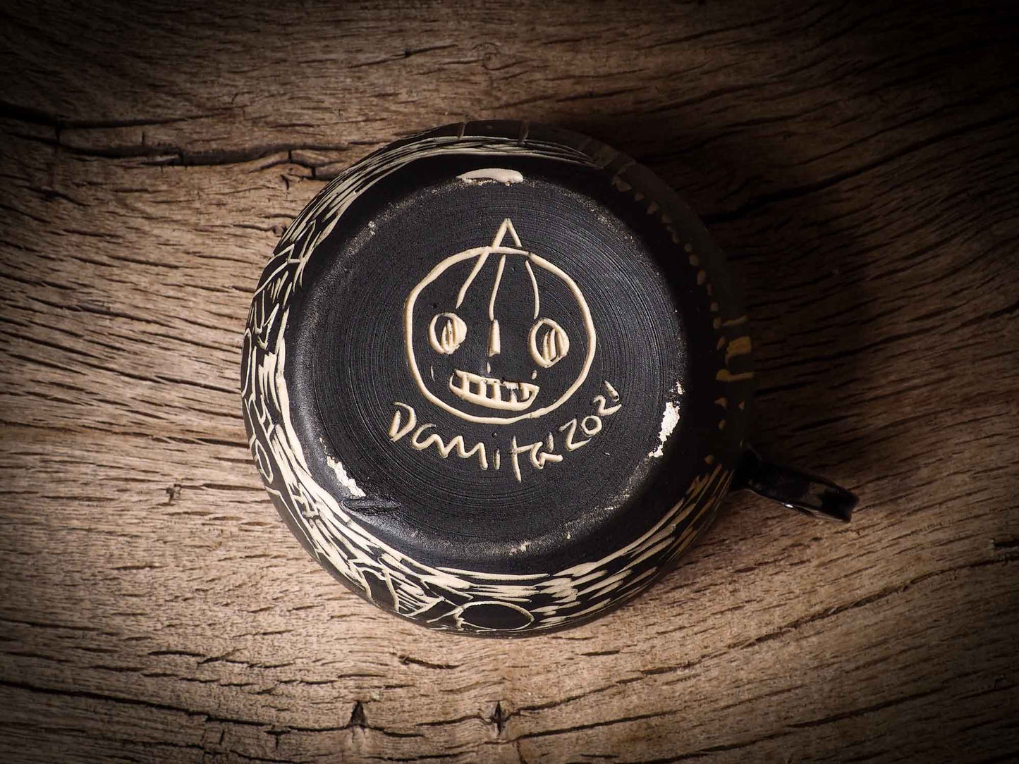 An original Halloween ceramic tumbler bowl by Idania Salcido, the artist behind Danita Art. Made with wheel thrown clay, hand carved and glazed by the artist. The carved witches, ghosts, goblins and vampires give it a nice, folk art primitive feel to it. Perfect for Halloween Candy, ice cream and fruit, a pet cat bowl.