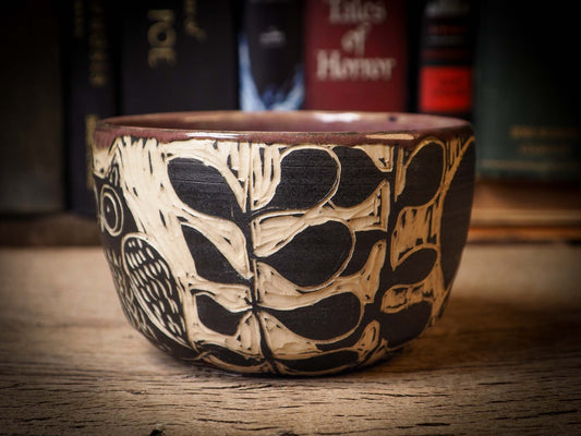 An original Halloween ceramic mug tumbler bowl handmade by Idania Salcido the artist behind Danita Art. Made with wheel thrown clay hand carved and glazed by the artist. Witches, ghosts, goblins and vampires give it a nice, folk art primitive feel to it. Perfect for Halloween Candy, ice cream and fruit, a pet cat bowl.