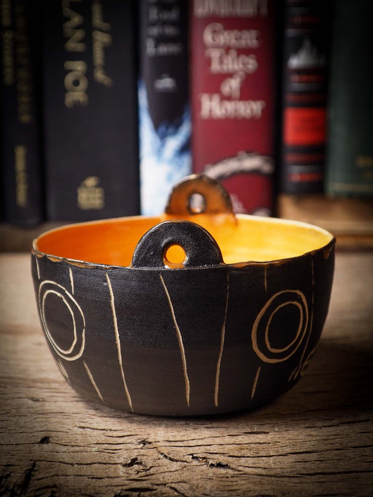 An original Halloween ceramic bowl bucket pail handmade by Idania Salcido the artist behind Danita Art. Made with wheel thrown clay hand carved and glazed by the artist. Witches, ghosts, goblins, black cats, vampires give a folk art primitive feel to it. Perfect for Halloween Candy, ice cream and fruit, a pet cat bowl.