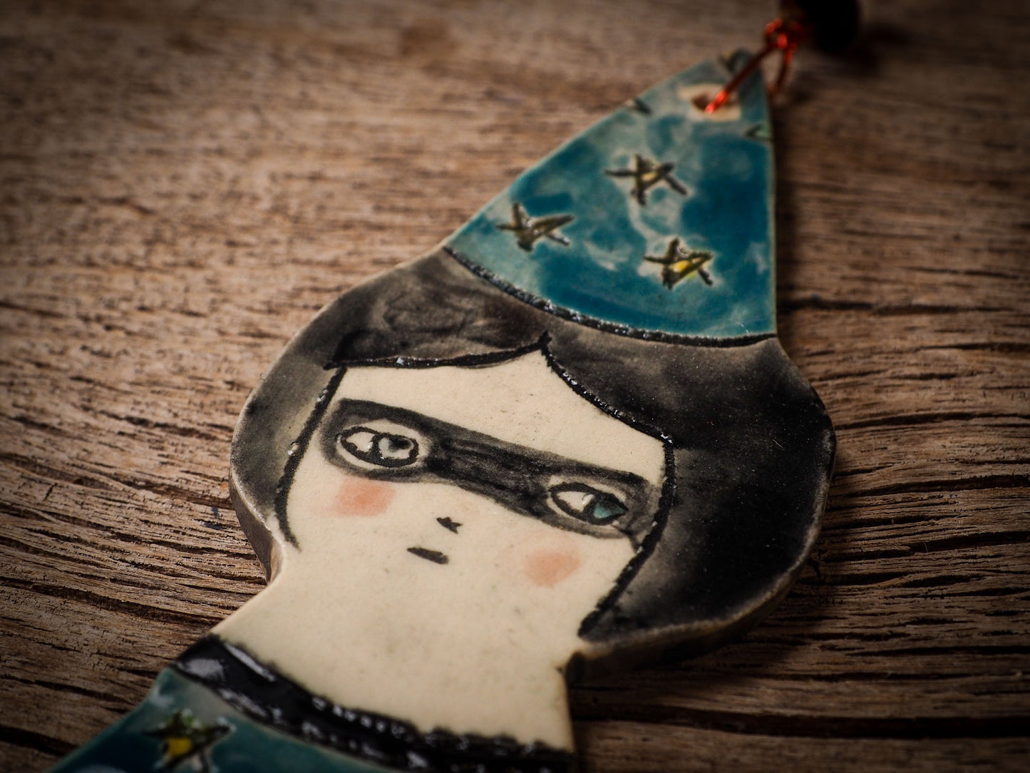 An original handmade Halloween ornament by Idania Salcido, Danita Art. Each ornament is hand carved with pumpkins, witches, cats, jack-o-lanterns and moons. Made with fired glazed ceramics, this little witch, jack-o-lantern and cat is carved with delicate patterns that make each ornament a one of a kind work of art.
