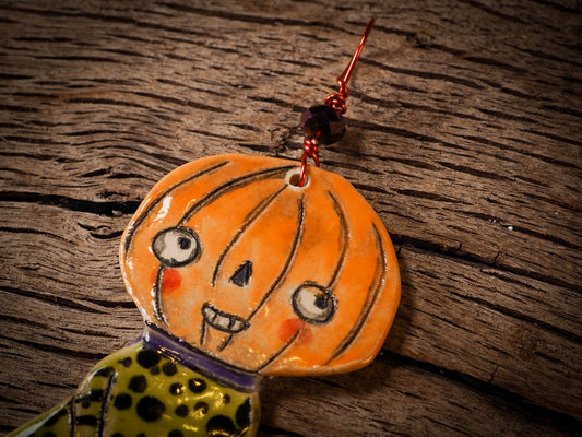 An original handmade Halloween ornament by Idania Salcido, Danita Art. Each ornament is hand carved with pumpkins, witches, cats, jack-o-lanterns and moons. Made with fired glazed ceramics, this little witch, jack-o-lantern and cat is carved with delicate patterns that make each ornament a one of a kind work of art.