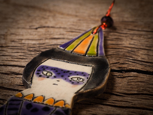 An original handmade Halloween ornament by Idania Salcido, Danita Art. Each ornament is hand carved with pumpkins, witches, cats, jack-o-lanterns and moons. Made with fired glazed ceramics, this little witch, jack-o-lantern and cat is carved with delicate patterns that make each ornament a one of a kind work of art.