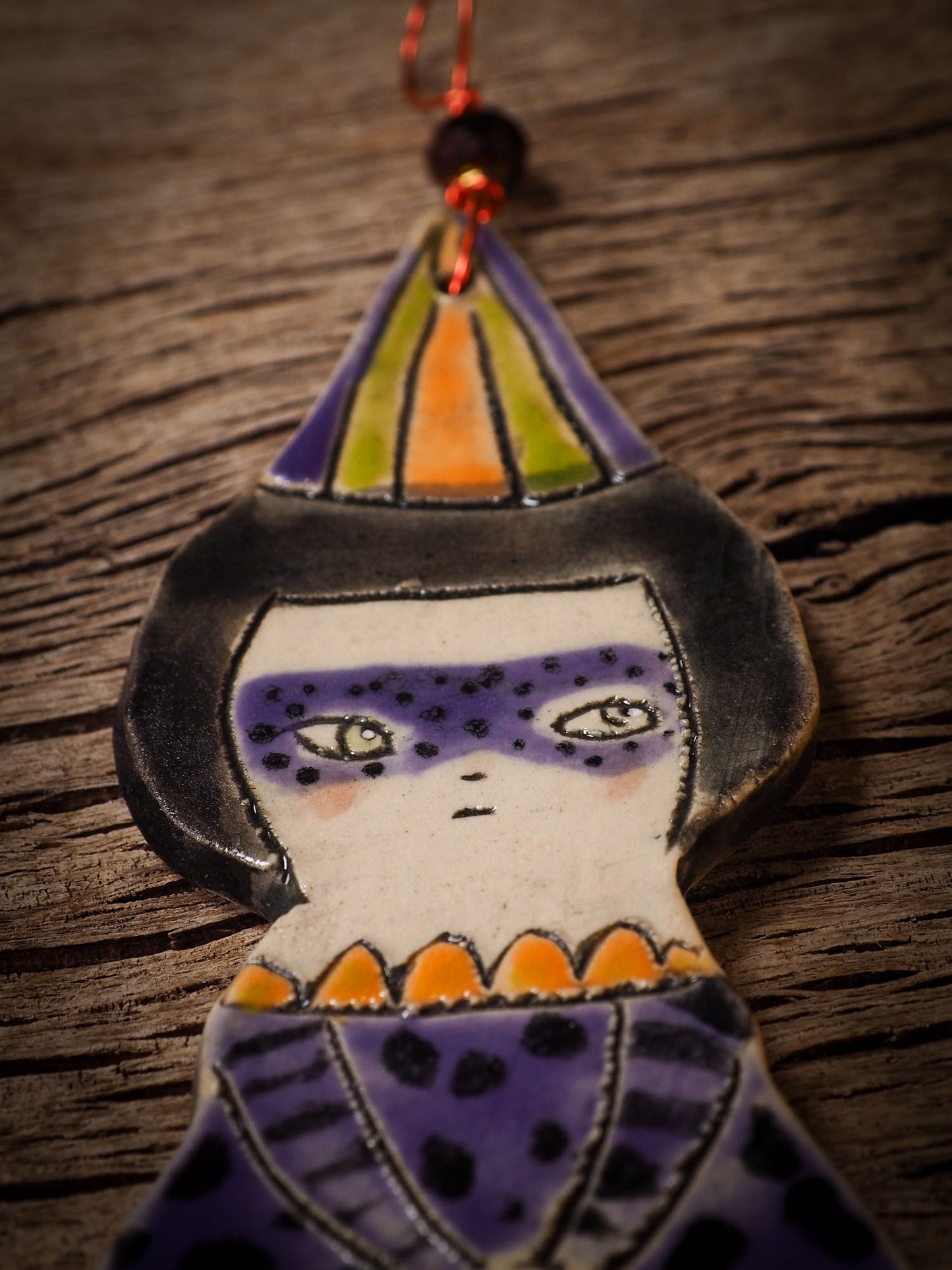 An original handmade Halloween ornament by Idania Salcido, Danita Art. Each ornament is hand carved with pumpkins, witches, cats, jack-o-lanterns and moons. Made with fired glazed ceramics, this little witch, jack-o-lantern and cat is carved with delicate patterns that make each ornament a one of a kind work of art.