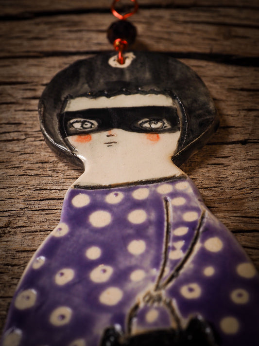 An original handmade Halloween ornament by Idania Salcido, Danita Art. Each ornament is hand carved with pumpkins, witches, cats, jack-o-lanterns and moons. Made with fired glazed ceramics, this little witch, jack-o-lantern and cat is carved with delicate patterns that make each ornament a one of a kind work of art.