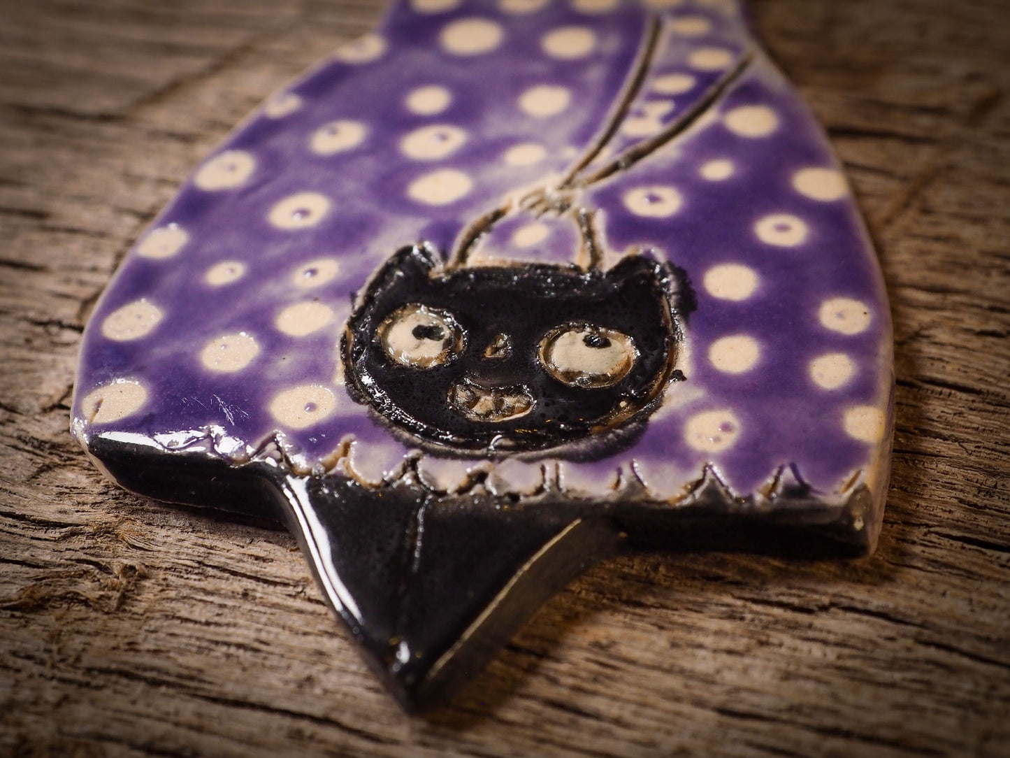 An original handmade Halloween ornament by Idania Salcido, Danita Art. Each ornament is hand carved with pumpkins, witches, cats, jack-o-lanterns and moons. Made with fired glazed ceramics, this little witch, jack-o-lantern and cat is carved with delicate patterns that make each ornament a one of a kind work of art.