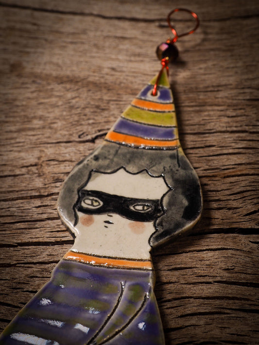 An original handmade Halloween ornament by Idania Salcido, Danita Art. Each ornament is hand carved with pumpkins, witches, cats, jack-o-lanterns and moons. Made with fired glazed ceramics, this little witch, jack-o-lantern and cat is carved with delicate patterns that make each ornament a one of a kind work of art.