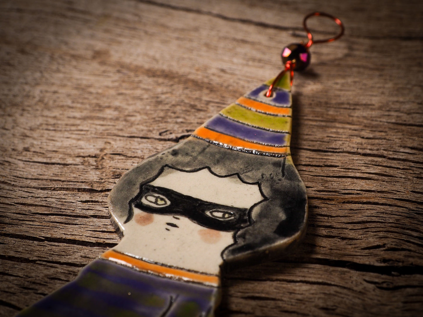 An original handmade Halloween ornament by Idania Salcido, Danita Art. Each ornament is hand carved with pumpkins, witches, cats, jack-o-lanterns and moons. Made with fired glazed ceramics, this little witch, jack-o-lantern and cat is carved with delicate patterns that make each ornament a one of a kind work of art.