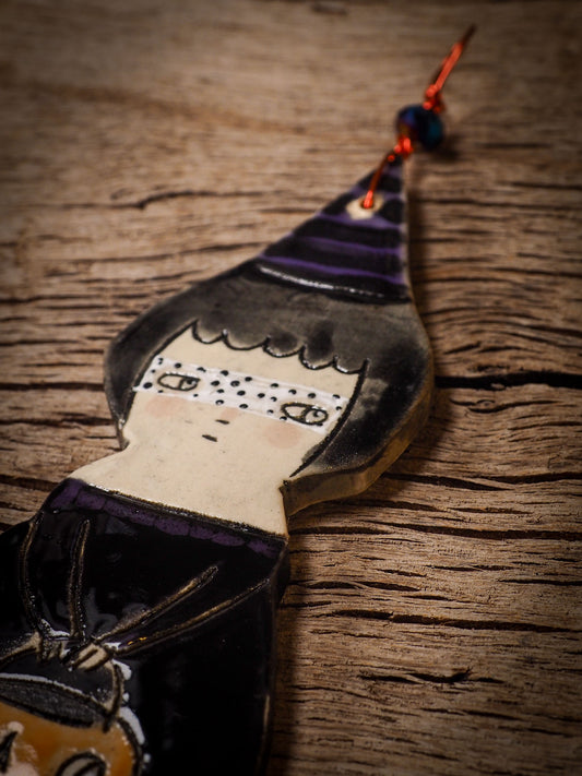 An original handmade Halloween ornament by Idania Salcido, Danita Art. Each ornament is hand carved with pumpkins, witches, cats, jack-o-lanterns and moons. Made with fired glazed ceramics, this little witch, jack-o-lantern and cat is carved with delicate patterns that make each ornament a one of a kind work of art.