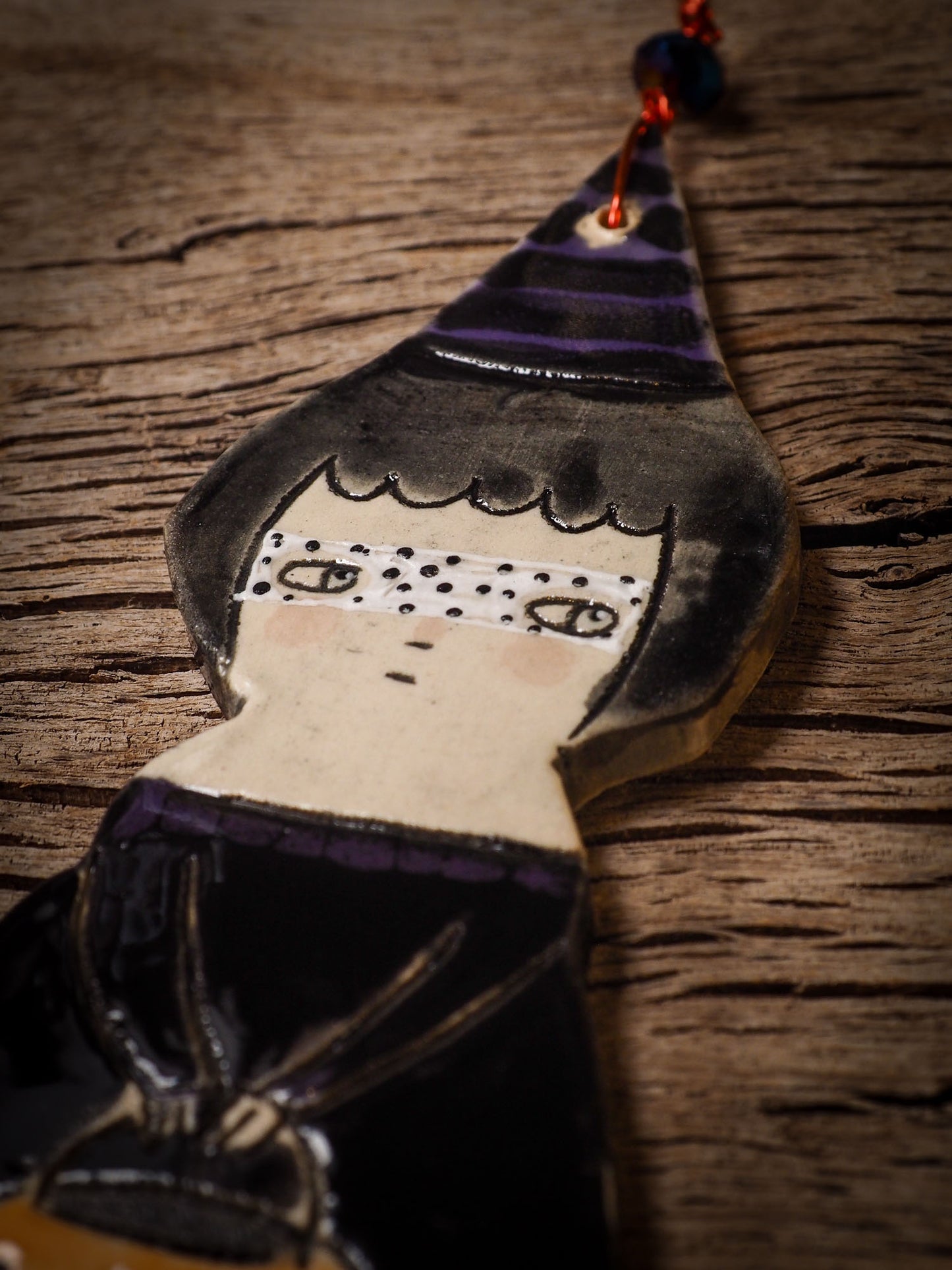 An original handmade Halloween ornament by Idania Salcido, Danita Art. Each ornament is hand carved with pumpkins, witches, cats, jack-o-lanterns and moons. Made with fired glazed ceramics, this little witch, jack-o-lantern and cat is carved with delicate patterns that make each ornament a one of a kind work of art.