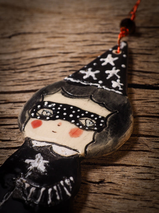 An original handmade Halloween ornament by Idania Salcido, Danita Art. Each ornament is hand carved with pumpkins, witches, cats, jack-o-lanterns and moons. Made with fired glazed ceramics, this little witch, jack-o-lantern and cat is carved with delicate patterns that make each ornament a one of a kind work of art.