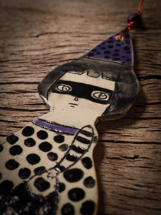 An original handmade Halloween ornament by Idania Salcido, Danita Art. Each ornament is hand carved with pumpkins, witches, cats, jack-o-lanterns and moons. Made with fired glazed ceramics, this little witch, jack-o-lantern and cat is carved with delicate patterns that make each ornament a one of a kind work of art.